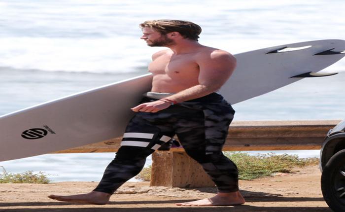 Liam Hemsworth Hits the Beach and Shows Off His Abs