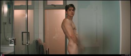 Nick Robinson peeing behind frosted glass.