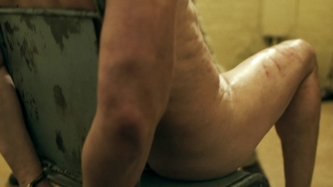 Vincent Perez Naked as Didier Levy. Butt, hands tied behind back, sitting in chair. 180189