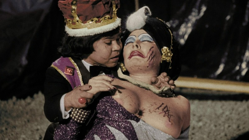 Susan Tyrrell Nude in Forbidden Zone. Breasts, dark red lipstick, dying. 780616