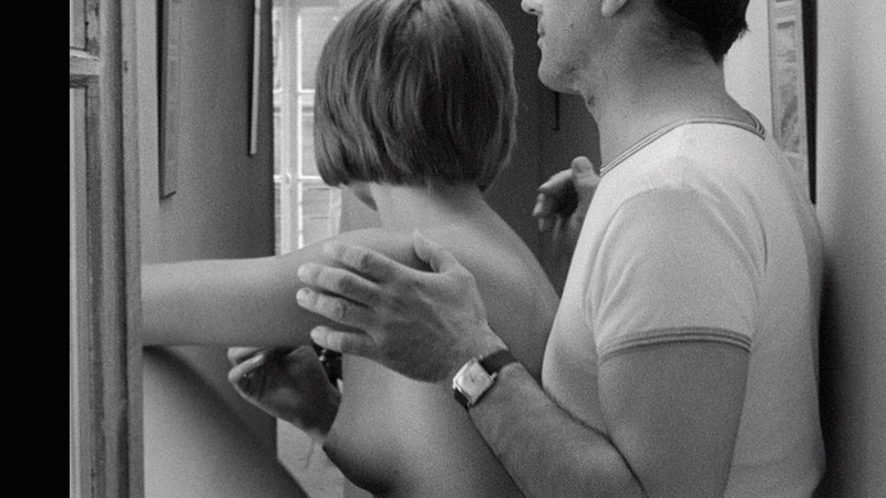 Nudes of Charlotte from A Married Woman. Breasts, black and white, man behind woman. 790104
