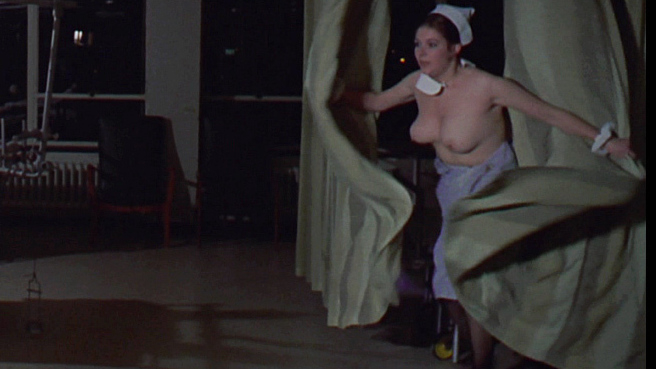 Carol Drinkwater Naked as Nurse Feeley. Breasts, black hair, gown pulled down. 674073