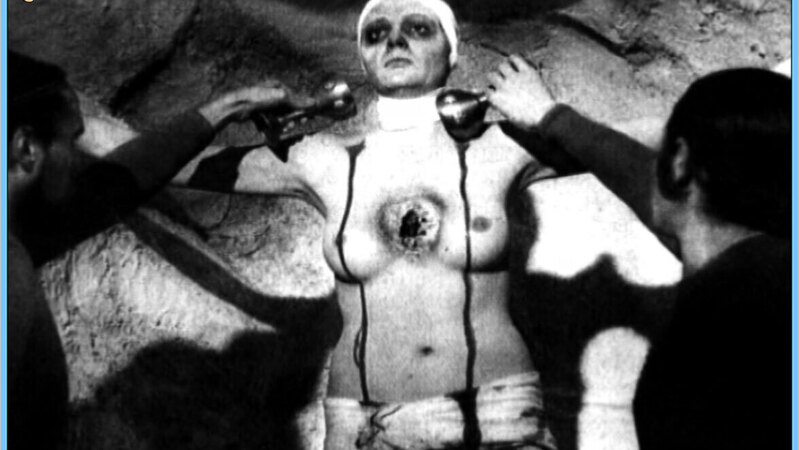 Rita Calderoni Nude as Marcia Lyutak. Breasts, black and white, blood on body. 562604