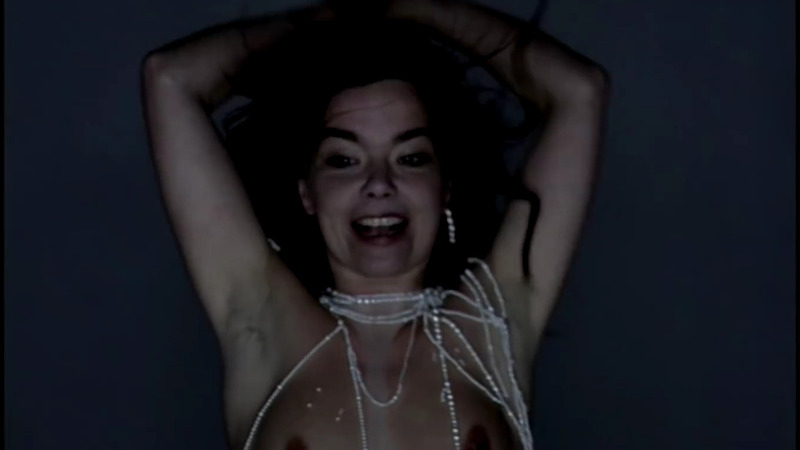 Björk Nude as Herself. Breasts, blue background, hands over head. 793616