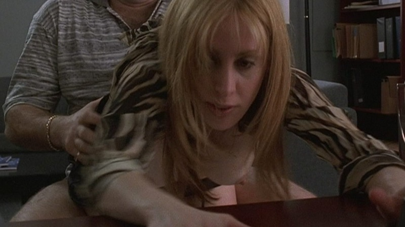 Connie DeSapio from The Sopranos Naked. Breasts, bent over desk, black top. 750539