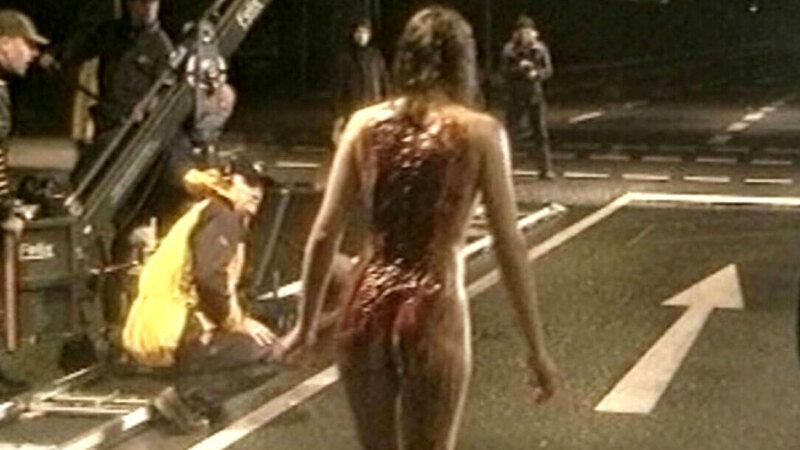 Lynn Wilson from Tattoo Naked. Butt, back exposed, being filmed. 602567
