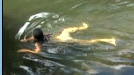 Megan McNally Nude in Three Bad Men. Butt, black hair, in water. 641860