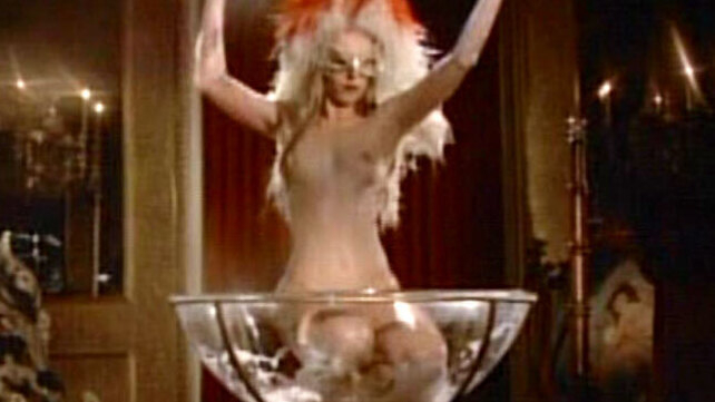 Dino Head Nude as Lady Lil / Stripper in Red. Breasts, blonde, feather headdress. 548636
