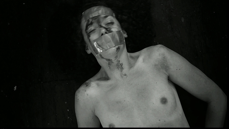 Ashlynn Yennie Nude in The Human Centipede II. Breasts, black and white, laying on floor. 706540