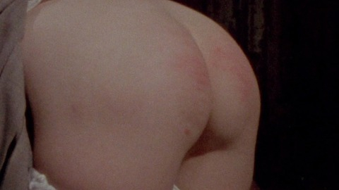 Girl on Guillotine from Bloodsucking Freaks Naked. Butt, bush, hand marks on butt. 749483