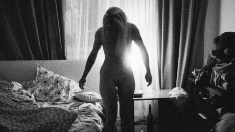Angela Raducani from Do Not Expect Too Much from the End of the World Naked. Breasts, Bush, back lit, black and white. 999953